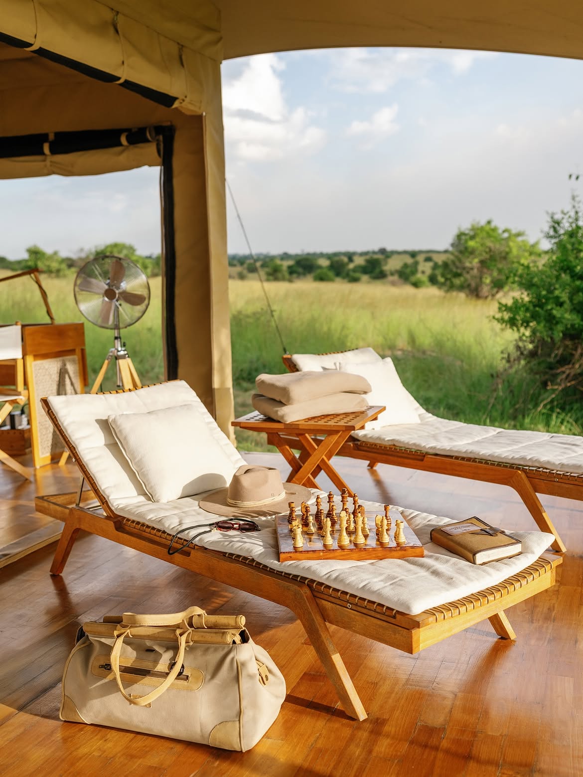 Tent lounger deck with chess set overlooking the plains