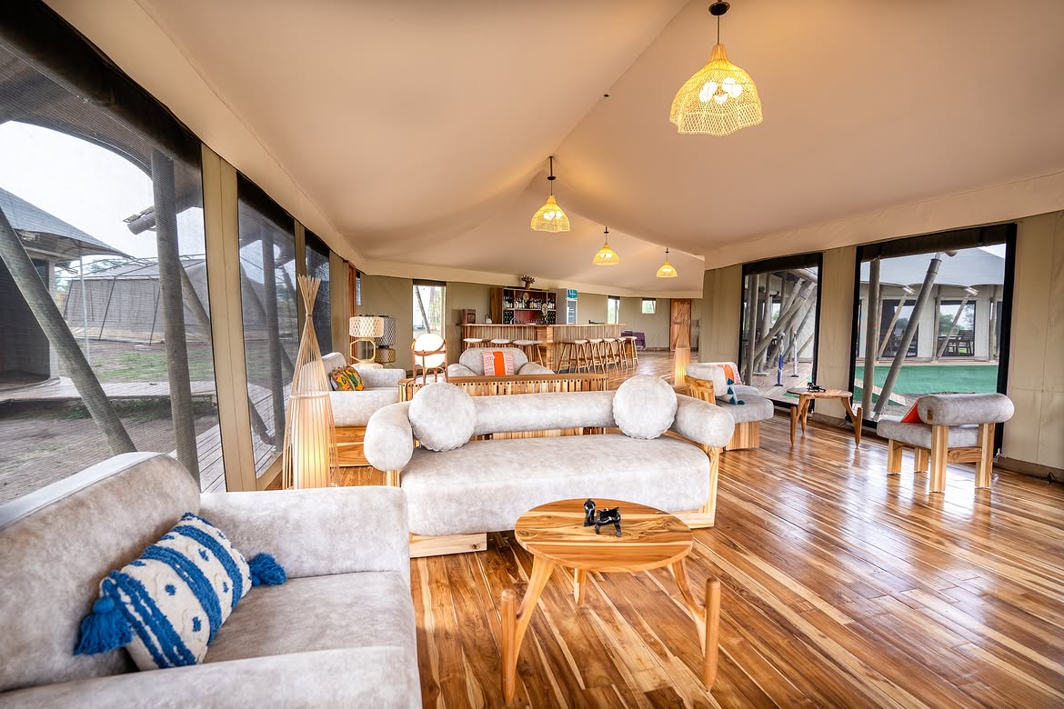 Main lounge with plush sofas and bar at Malaika Camp