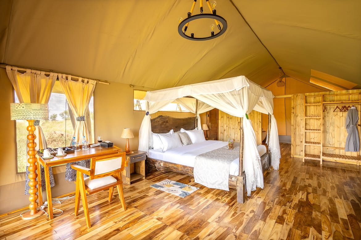 Canopy king bed in a Malaika luxury tent with Serengeti view