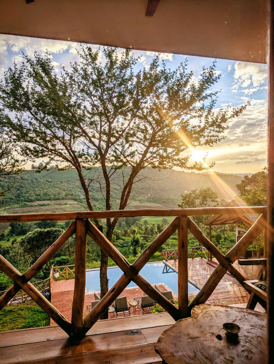Sunrise view of the pool and Meru foothills from a Mvuli Lodge balcony