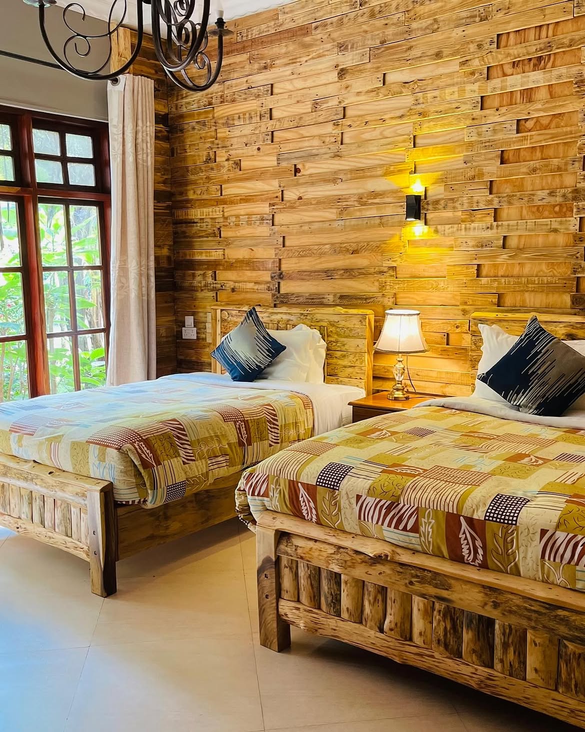 Twin bedroom with reclaimed timber walls at Under The Shade