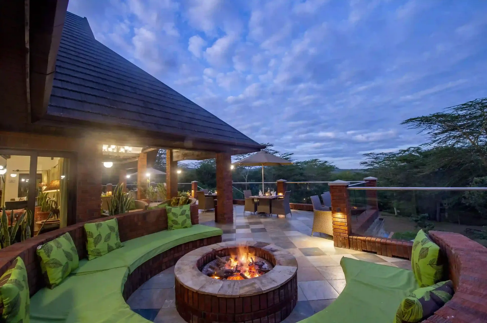 Fire pit terrace with forest views at The Retreat at dusk